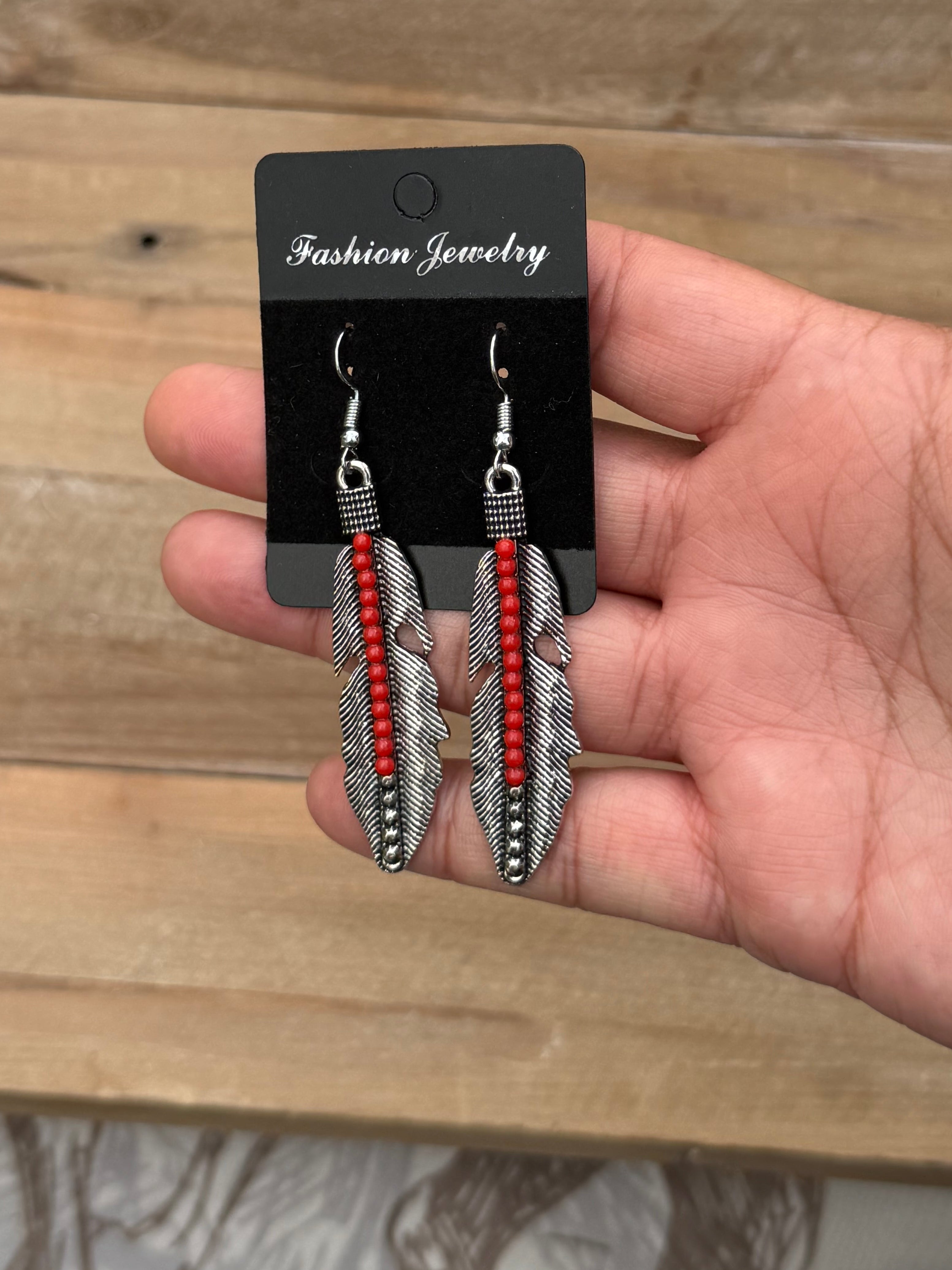 Silver and red beaded feather earrings